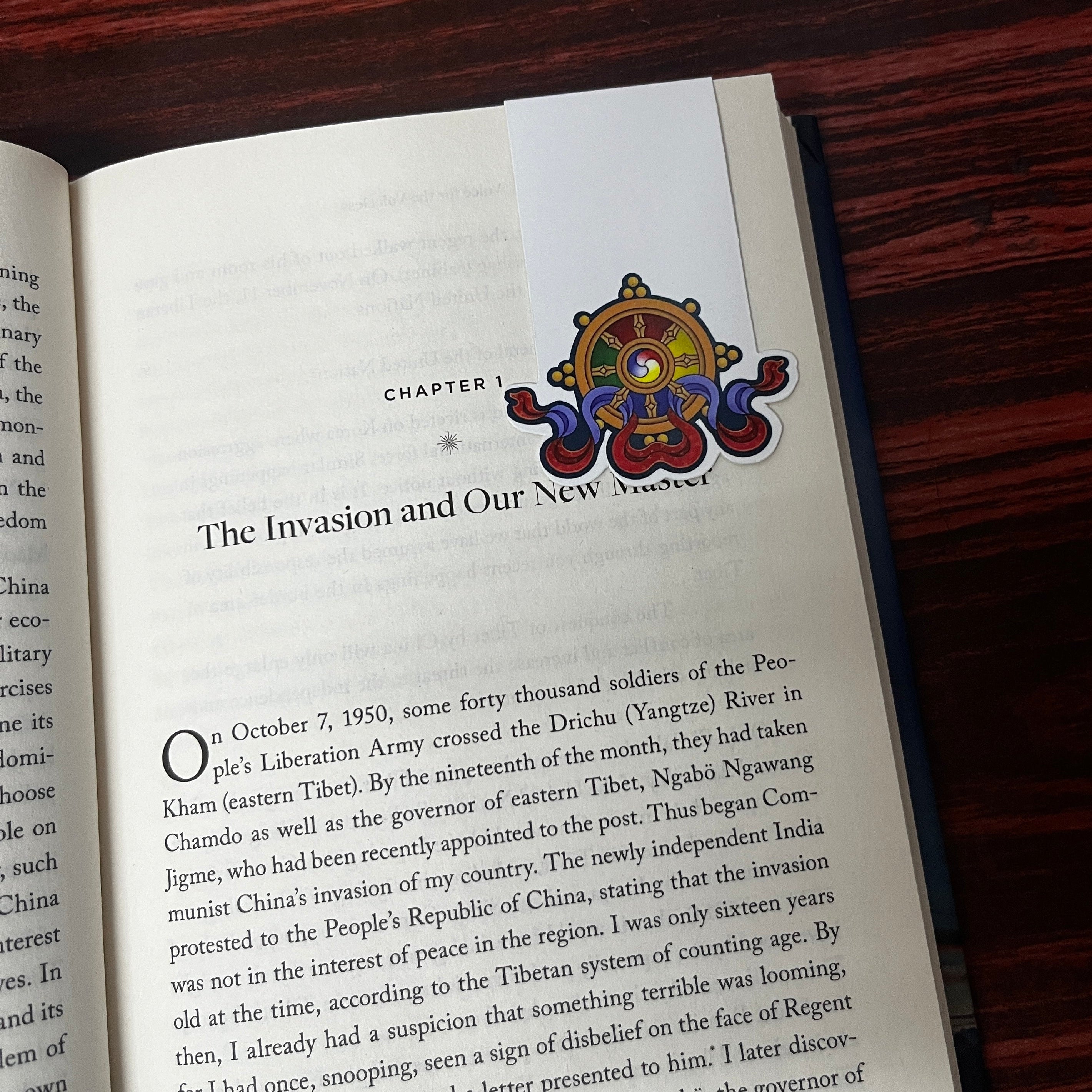 Open book with a colorful bookmark on a wooden surface