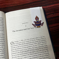 Open book with a decorative bookmark on a wooden surface